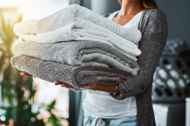 Mission accomplished, fresh and clean towels Shot of an unrecognizable woman doing her laundry at home towel stock pictures, royalty-free photos & images