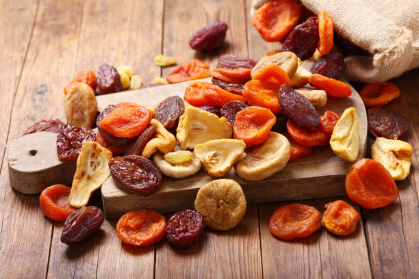 mix of dried fruits mix of dried fruits on wooden table dried fruit stock pictures, royalty-free photos & images