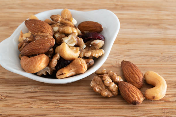 Mix of nuts on wooden background stock photo