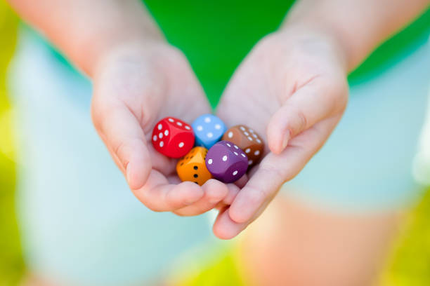 Mixed color dices in child's hands. Mixed color dices in child's hands. Board games for kids. Winner consept. dice photos stock pictures, royalty-free photos & images