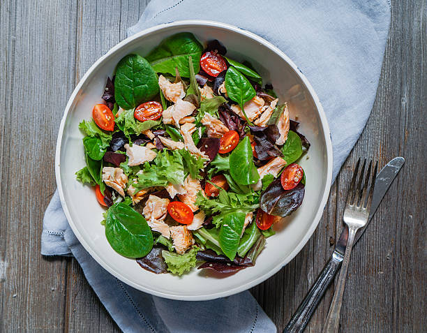 Mixed Green Salad with Grilled Salmon, Quinoa and Tomatoes stock photo