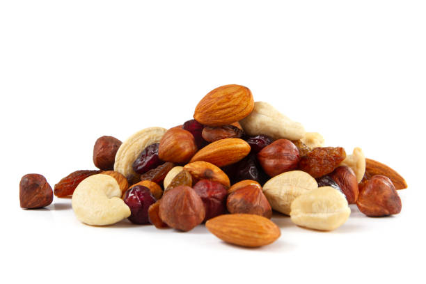Mixed Nuts and Dried Fruits Mixed nut isolated on white background. dried fruit stock pictures, royalty-free photos & images