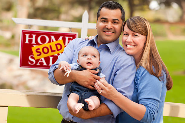 Mixed Race Couple, Baby, Sold Real Estate Sign Happy Mixed Race Couple with Baby in Front of Sold Real Estate Sign. in front of stock pictures, royalty-free photos & images