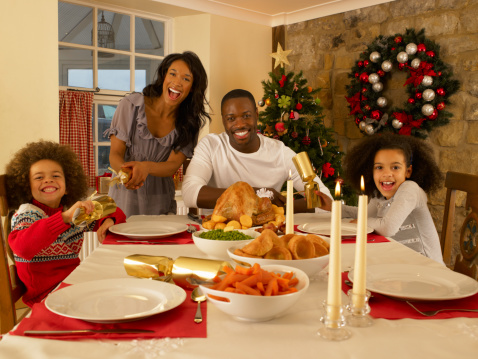 Mixed Race Family Having Christmas Dinner Stock Photo - Download Image