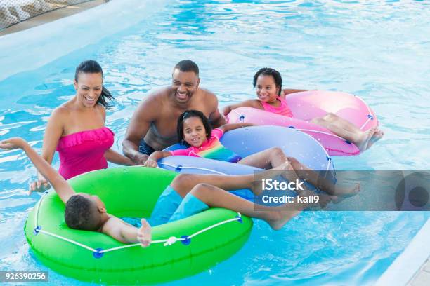 Mixed race family with three children at water park