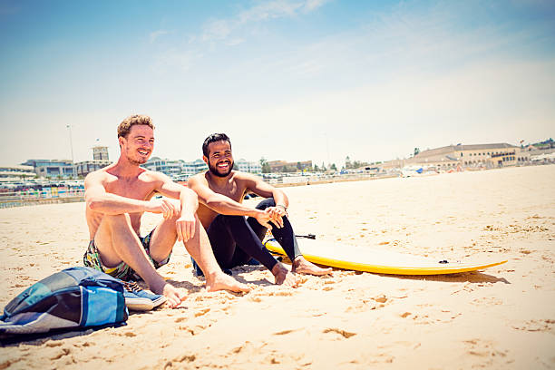 Mixed race friends with surfboard at Bondi Beach, Australia stock photo