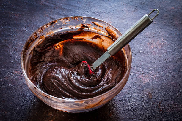 mixing bowl filled with homemade chocolate  dough - bolos de chocolate imagens e fotografias de stock