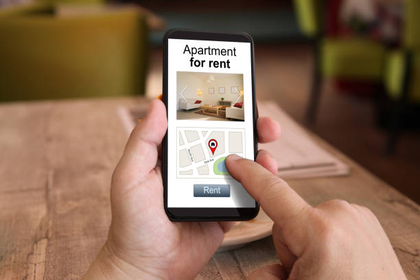 Mobile phone internet search apartment house holiday home rental Mobile phone internet search apartment house holiday home rental mobile real estate stock pictures, royalty-free photos & images