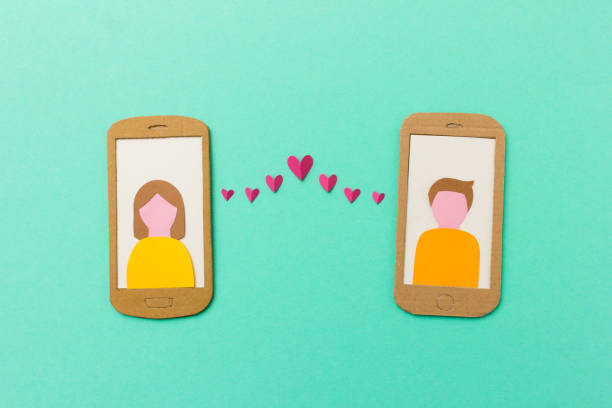 Mobile phone with red hearts flying from the screen - paper illustration image concept for online dating, dating apps stock photo