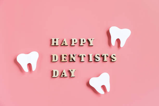 Mockup of tooth on pink background. Happy dentist day. Dental care concept. stock photo