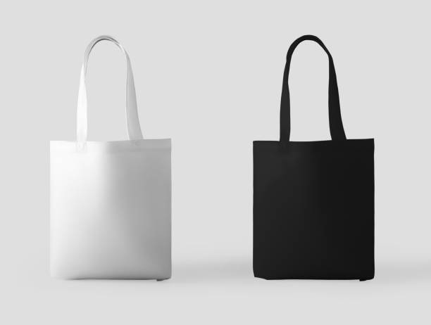 Mockup of white, black totebag with handle 3d rendering, standing and isolated on background. stock photo