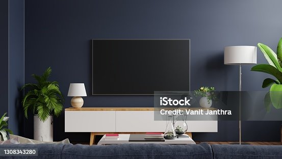 istock Mockup tv on cabinet in modern empty room with behind the dark blue wall. 1308343280