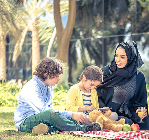 Modern Arab Family Young Arab mother with her son and daughter in a park. Image from iStockalypse Dubai, 2015, United Arab Emirates hot arabic girl stock pictures, royalty-free photos & images