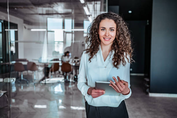 Modern business woman Waist up portrait modern business woman in the office with copy space manager stock pictures, royalty-free photos & images