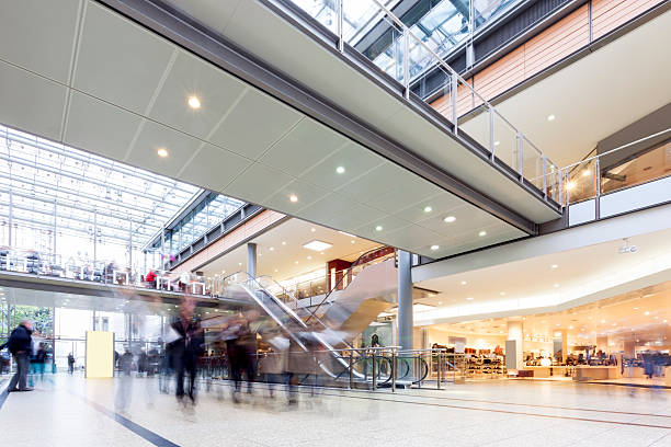 Modern Busy Shopping Mall with motion Blurred Shoppers stock photo