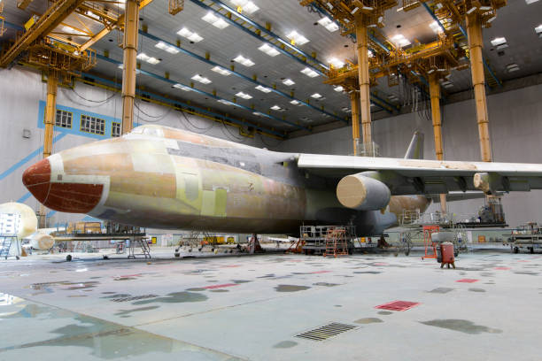 Modern cargo aircraft in the hangar Cargo aircraft during the heavy maintenance and painting military base stock pictures, royalty-free photos & images