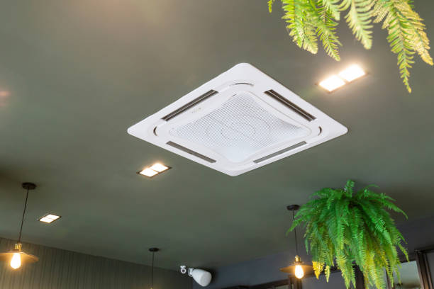Modern ceiling mounted cassette type air conditioning system in coffee shop stock photo