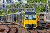 istock Modern double-deck (bi-level) electric commuter train with yellow front and doors 1336816269