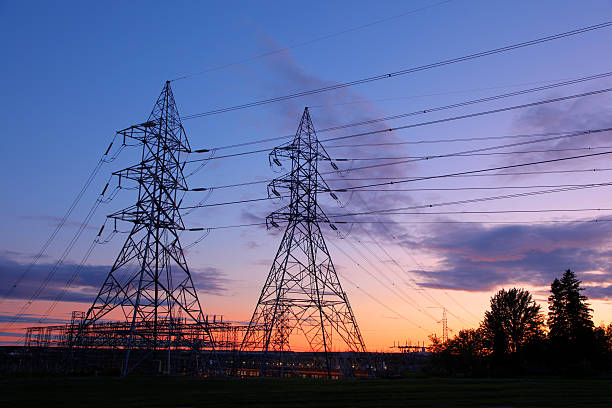 Modern Electricity Pylons and Lines at Sunset  buzbuzzer energy cable steel cable stock pictures, royalty-free photos & images