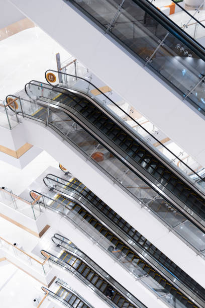 Modern escalators across different floors in a shopping mall stock photo