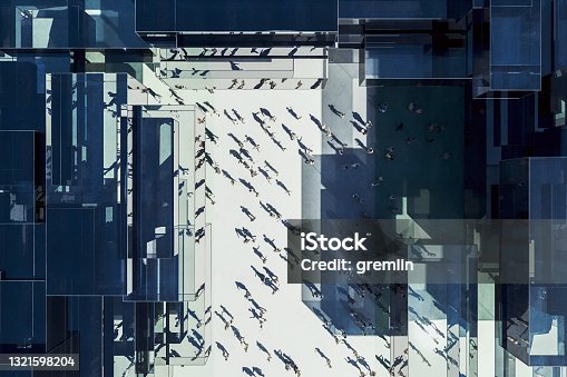 istock Modern glass office building with business people from above 1321598204
