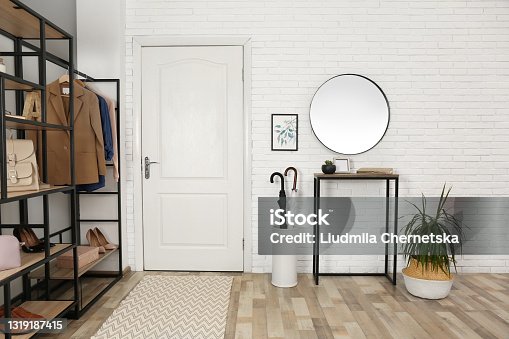 istock Modern hallway interior with mirror and storage unit 1319187415