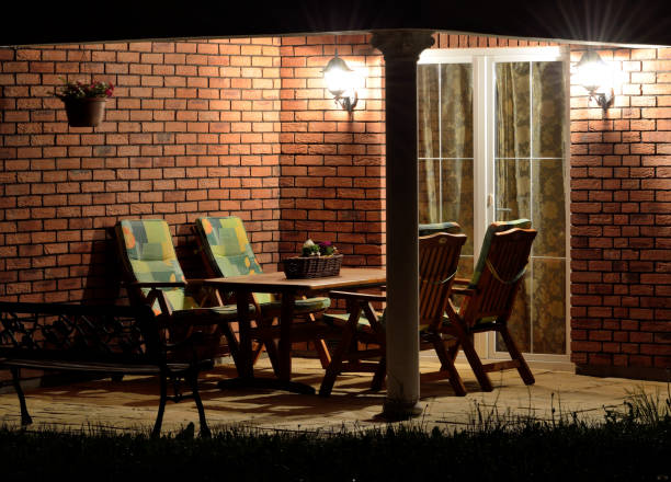 Modern house terrace (patio) with garden furniture at night stock photo