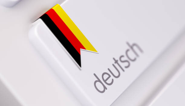 Modern Keyboard with German Language Option in German: Online Dictionary Concept High quality 3d render of a modern keyboard with German text and German flag. Derman keyboard button has a German flag icon on it and it is in focus. Horizontal composition with copy space. german culture stock pictures, royalty-free photos & images