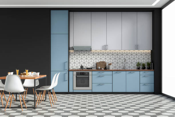 Modern kitchen and dining room on retro tiled floor stock photo