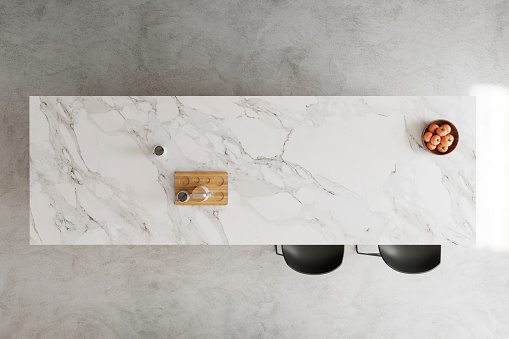 Marble kitchen island countertop top view, bar stools, concrete floor and details. Copy space template. Render.