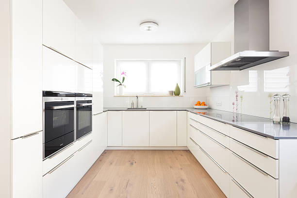 Modern Kitchen modern white kitchen wood laminate flooring stock pictures, royalty-free photos & images