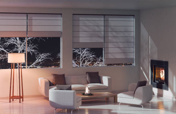 Modern Living room at night Modern apartment at night with a fireplace in a living room 3D render Image roller blinds stock pictures, royalty-free photos & images