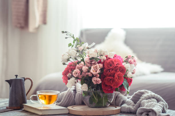 Modern Living room interior design with artificial flower vase Still life of a vase with roses in the living room. The concept of home comfort. flower arrangement stock pictures, royalty-free photos & images