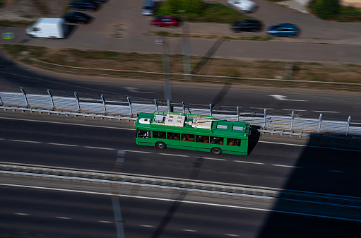 A modern low-floor trolleybus on the overpass. Ecologically clean transport of a modern city. Blurred motion