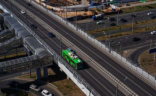 A modern low-floor trolleybus on the overpass. Ecologically clean transport of a modern city