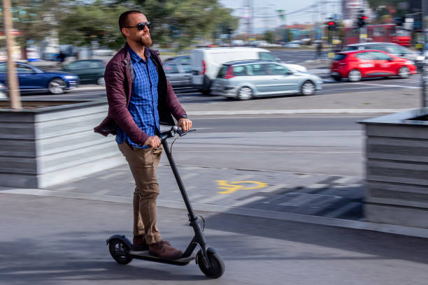 Modern man with sunglasses on an electric scooter stock photo