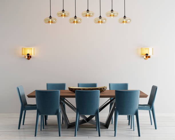 Modern minimalistic dining room interior with beige empty walls, a concrete table with blue chairs near it. stock photo