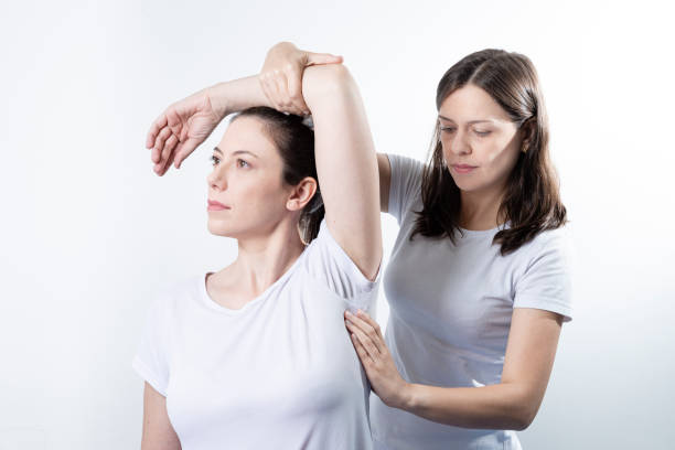 A modern rehabilitation physiotherapy woman at work with woman client stock photo