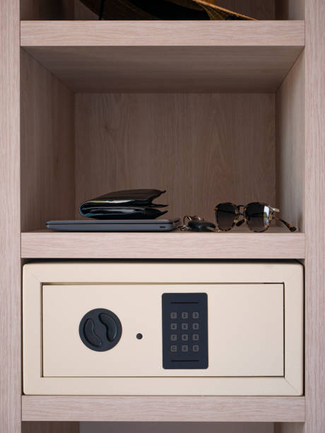 Modern safe in cabinet, Security Safe Box in hotel room with personal items, wallet, car keys, and sunglasses stock photo