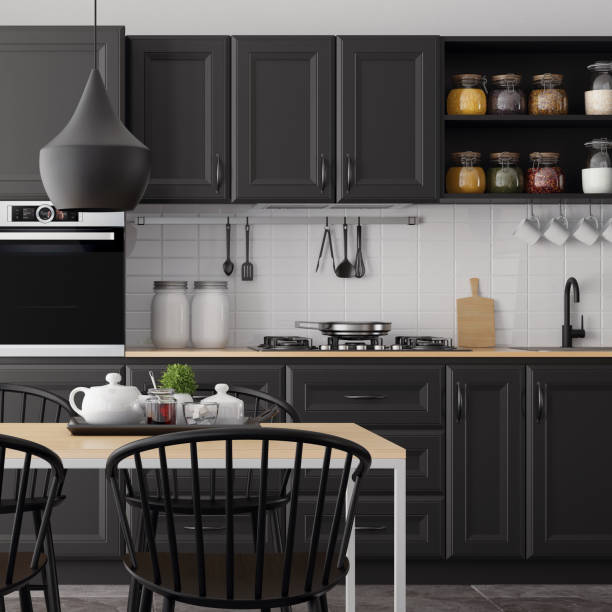 Modern Scandinavian kitchen and dining room with matte black traditional cabinet design stock photo