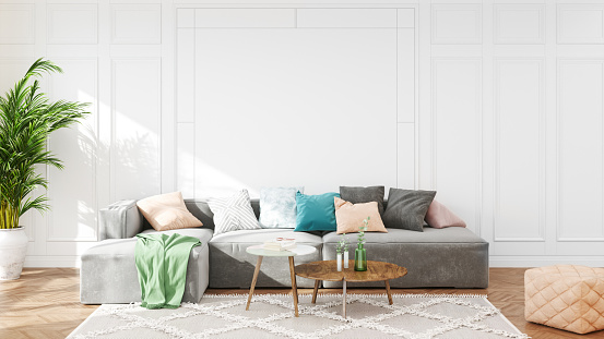 Scandinavian interior design living room with white wall panels and pastel colored furniture.