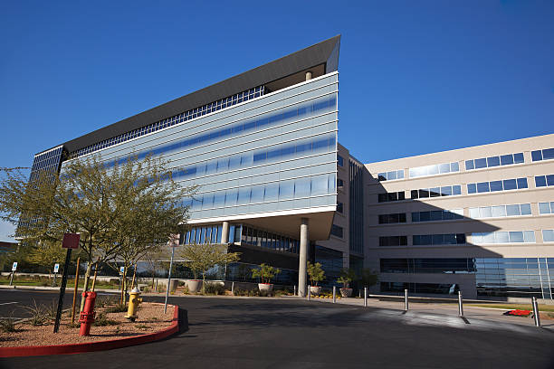 Modern Scottsdale Medical Business Building Scottsdale Arizona angular business building modern 20th century style on a clear day with palo verde trees set on a bright blue clear sky background hospital building stock pictures, royalty-free photos & images