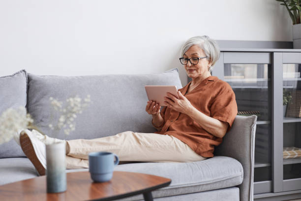 Modern Senior Woman Relaxing at Home stock photo
