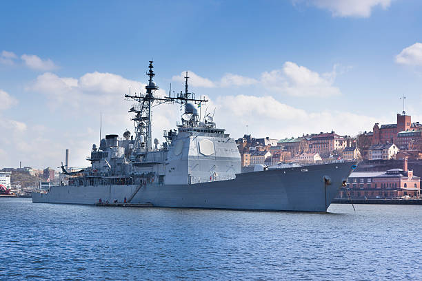 Modern warship in harbour A modern warship is anchored in port with a European city in the background (Stockholm) destroyer stock pictures, royalty-free photos & images
