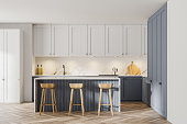 istock Modern white and gray kitchen with bar 1290994424