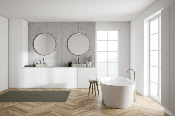 Modern white bathroom, tub and sink Side view of modern bathroom with white walls, wooden floor, double sink with two round mirrors and comfortable bathtub. 3d rendering vanity stock pictures, royalty-free photos & images