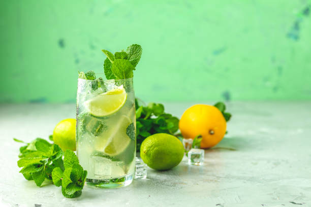 Mojito cocktail with lime and mint in highball glass stock photo