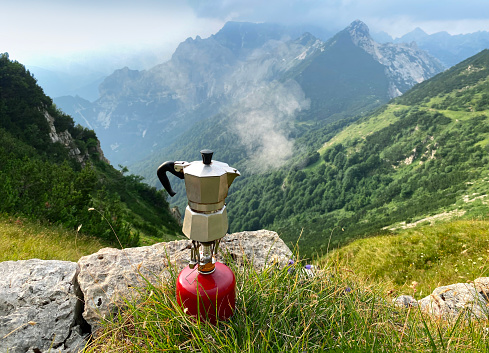 Moka coffee on portable camping stove in the mountain. Mount Carega, Italy.