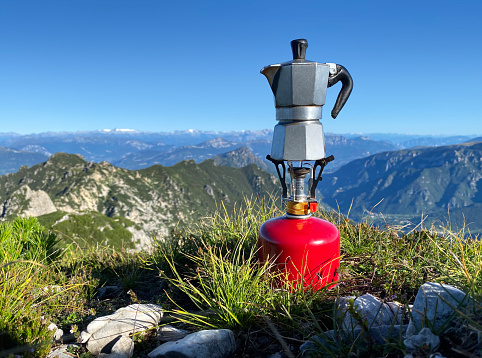Moka coffee on portable camping stove on top of the mountain