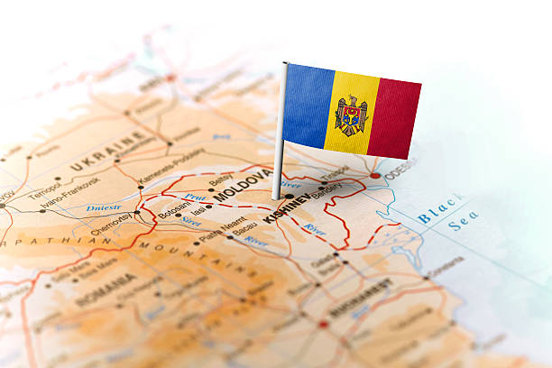 Moldova pinned on the map with flag The flag of Moldova pinned on the map. Horizontal orientation. Macro photography. moldova stock pictures, royalty-free photos & images